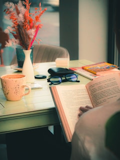 A peaceful home setting highlighting a senior reading a book with a tablet and phone on the side.