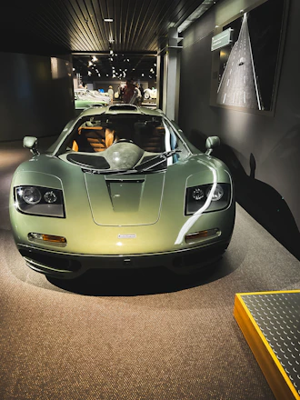 A sleek black and green luxury car showroom with a modern import process infographic on the wall.