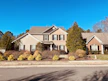 Cozy suburban home with a manicured lawn and a welcoming front porch under a clear blue sky.