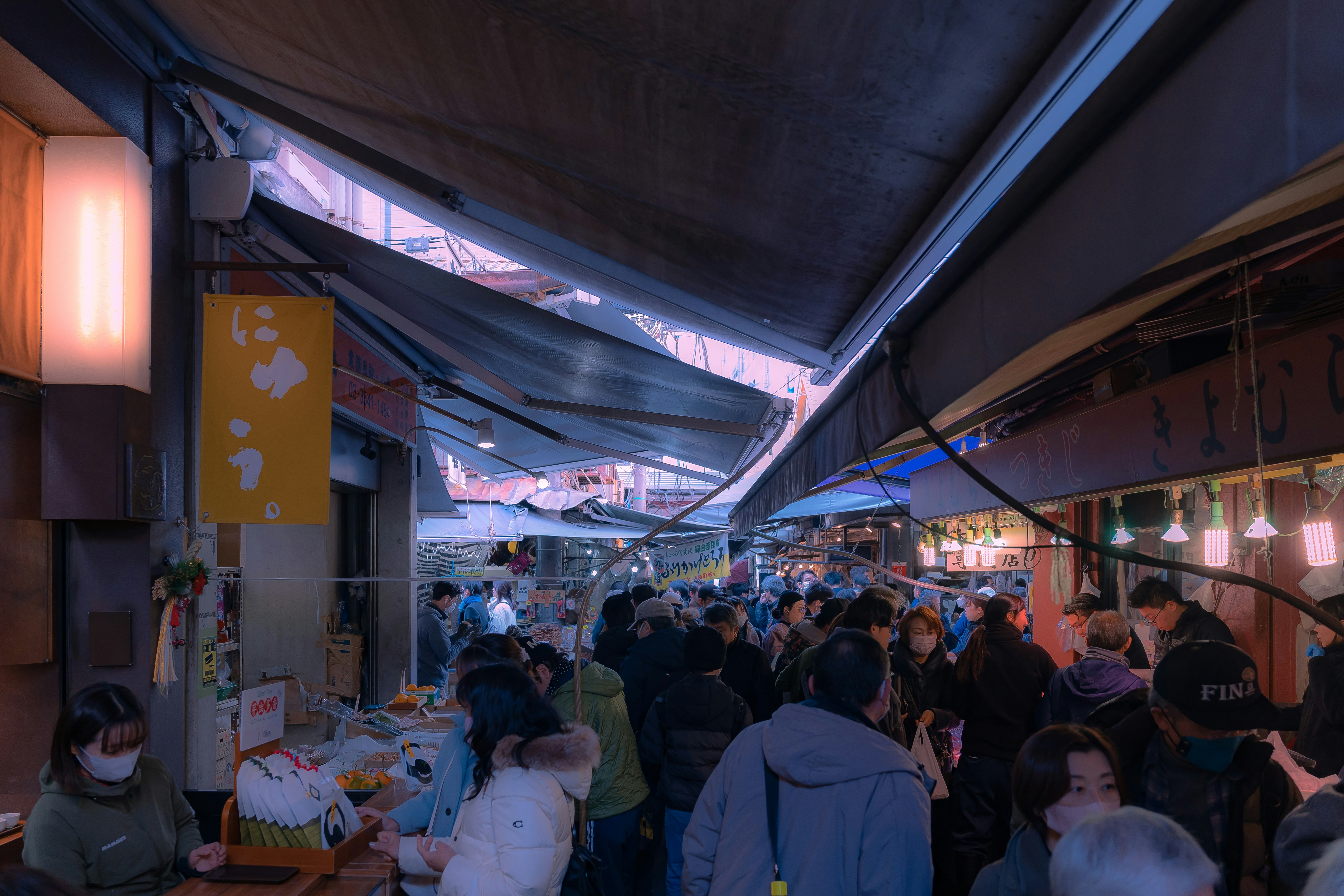 a group of people walking through a market