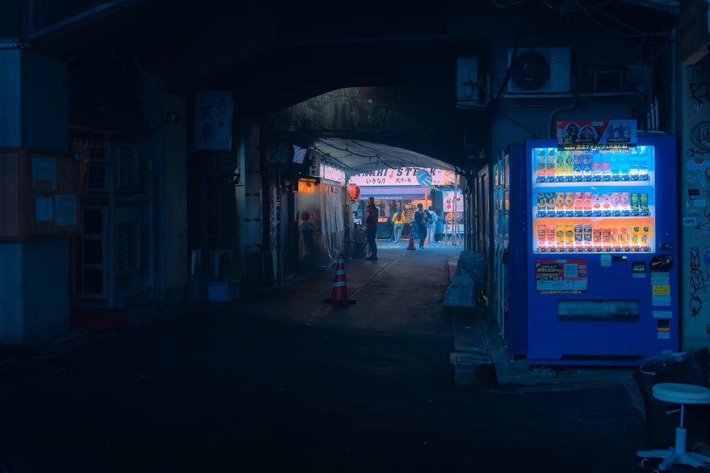 a vending machine is lit up in the dark