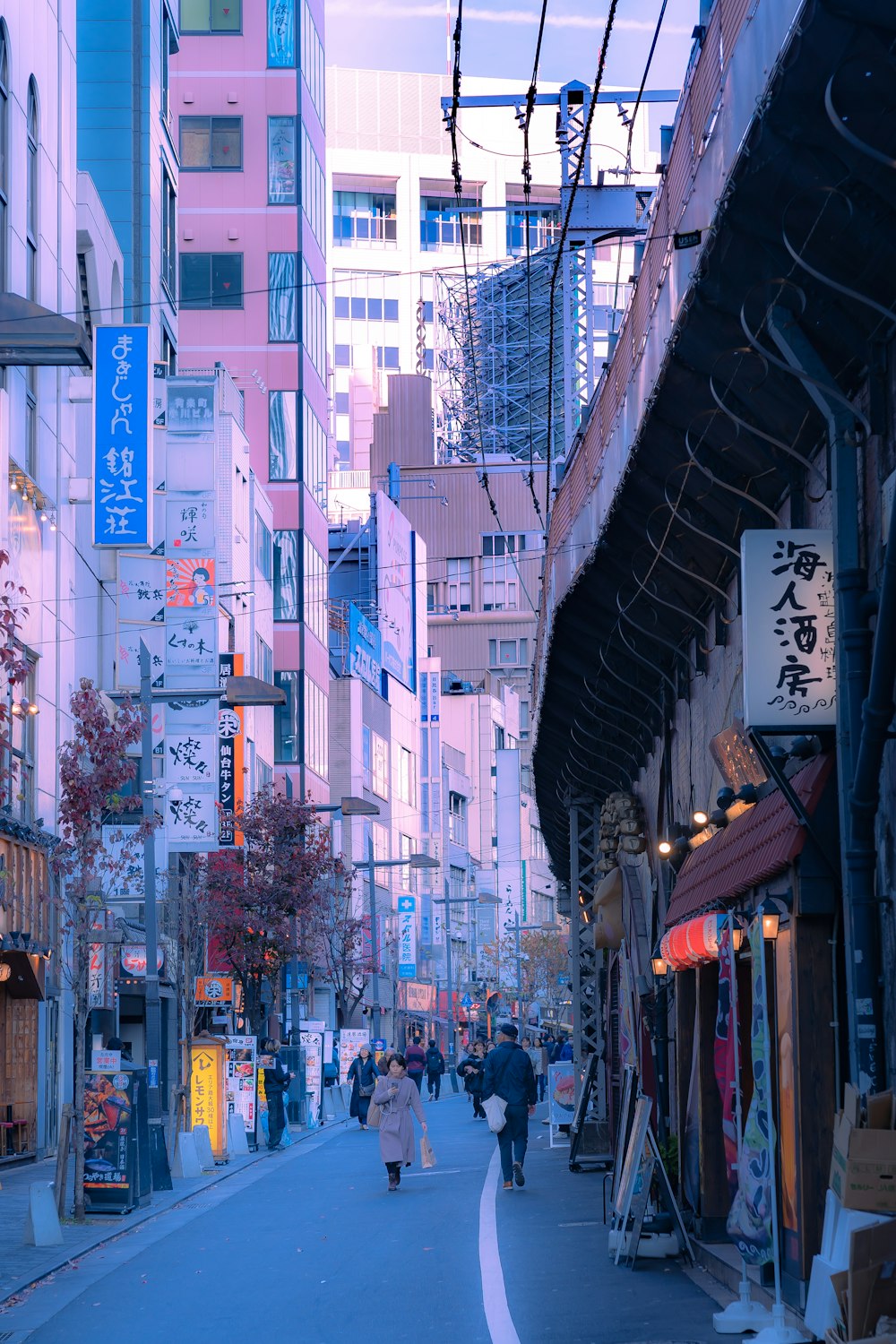 a city street lined with tall buildings and shops