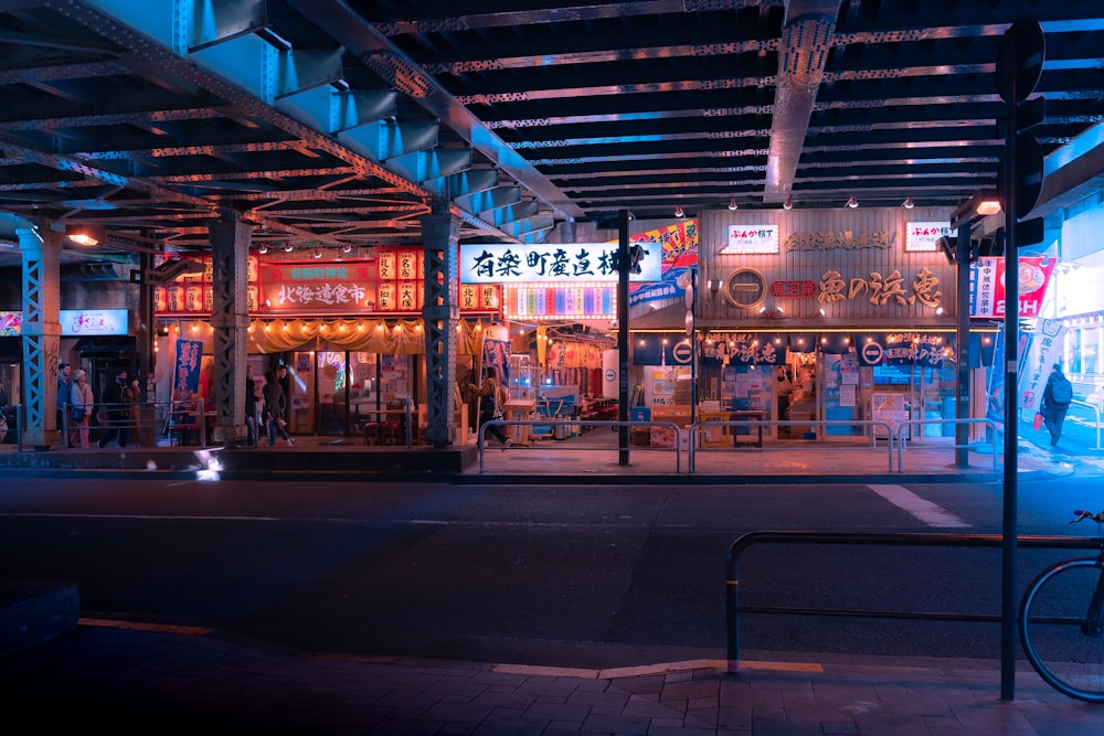 a city street at night with neon lights