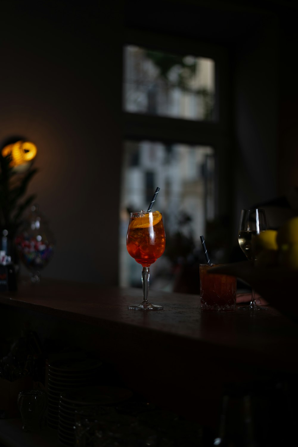 a glass of wine sitting on top of a wooden table