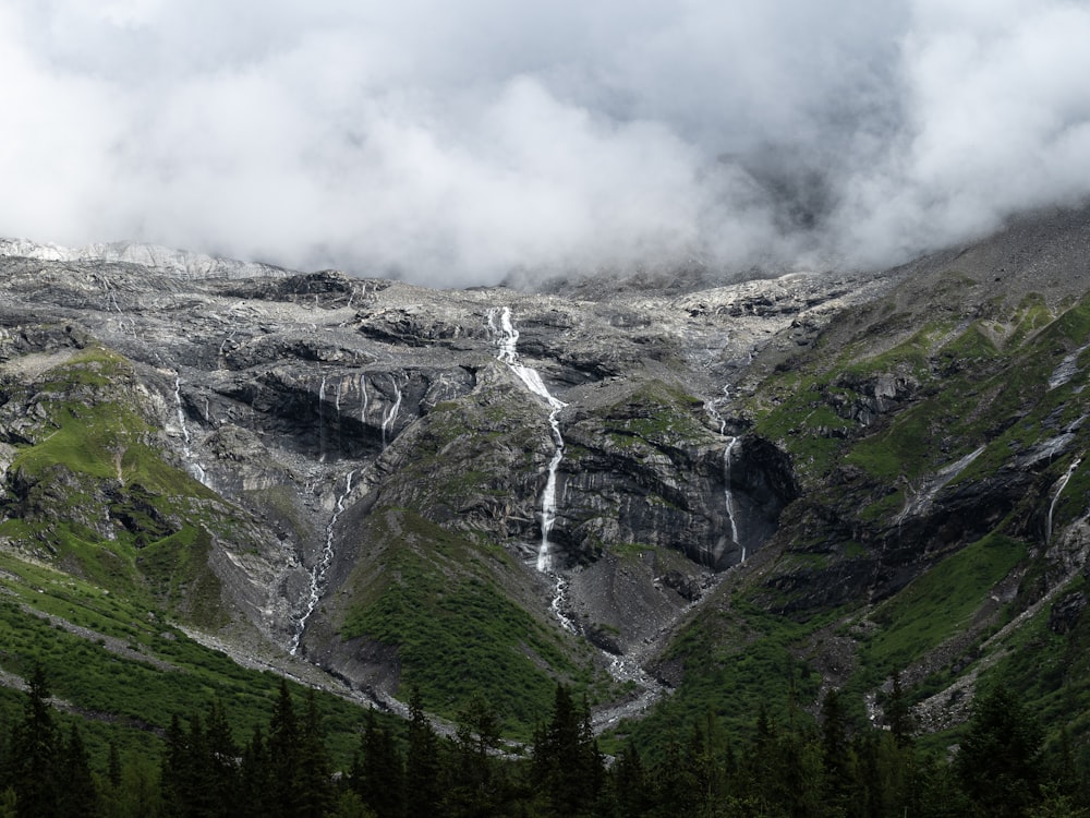 a view of a mountain with a waterfall coming out of it