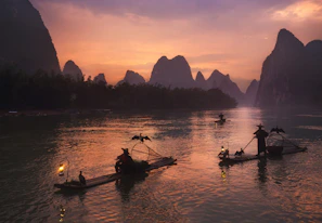 A scenic river cruise through the lush jungles of Laos at dusk