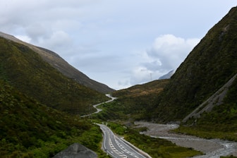 a winding road in the middle of a mountain range