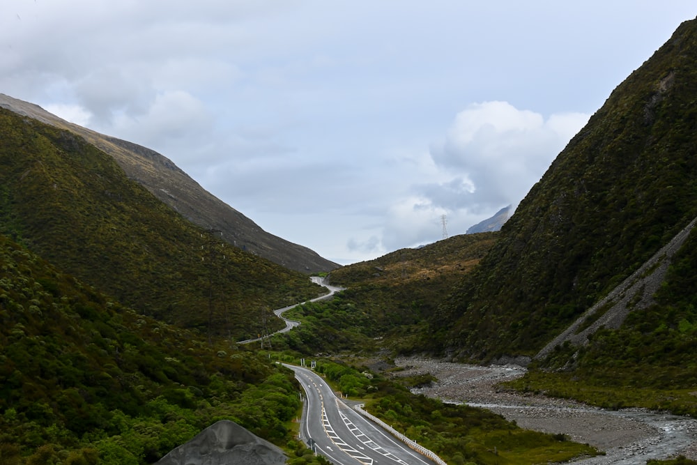 a winding road in the middle of a mountain range