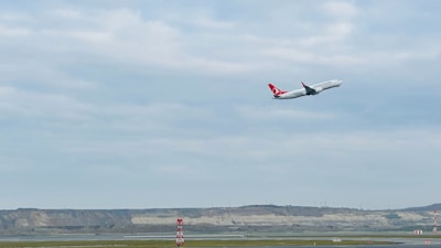 An airplane taking off with a backdrop of a global logistics network map.