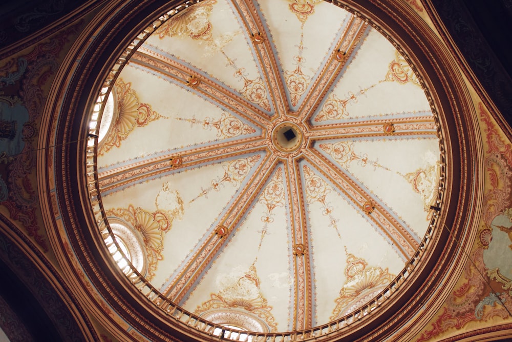 the ceiling of a building with a circular window