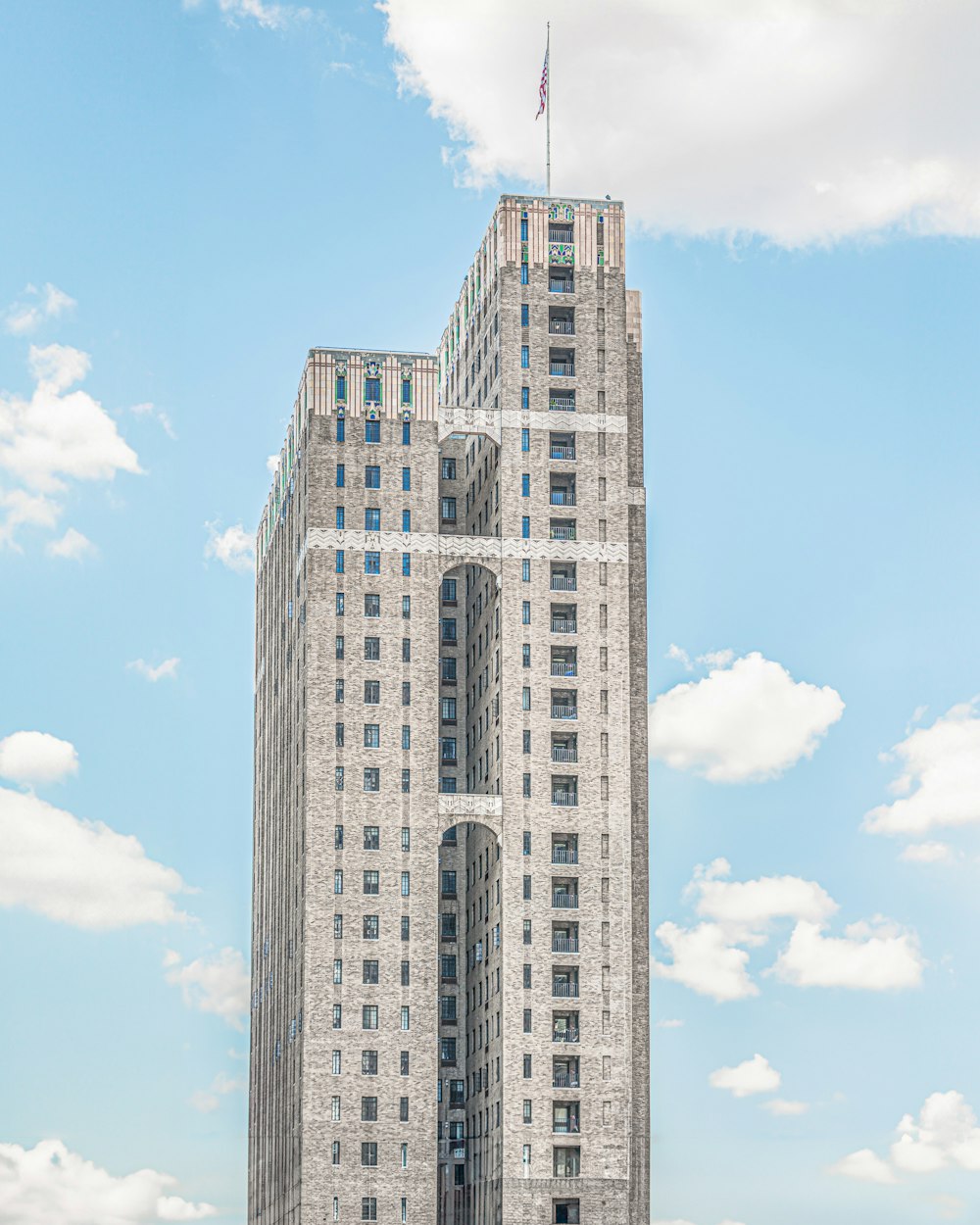 a tall white building with a flag on top of it