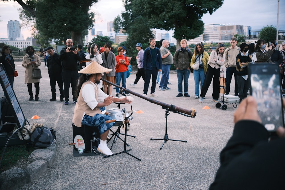 a woman sitting in a chair with a telescope in her hand