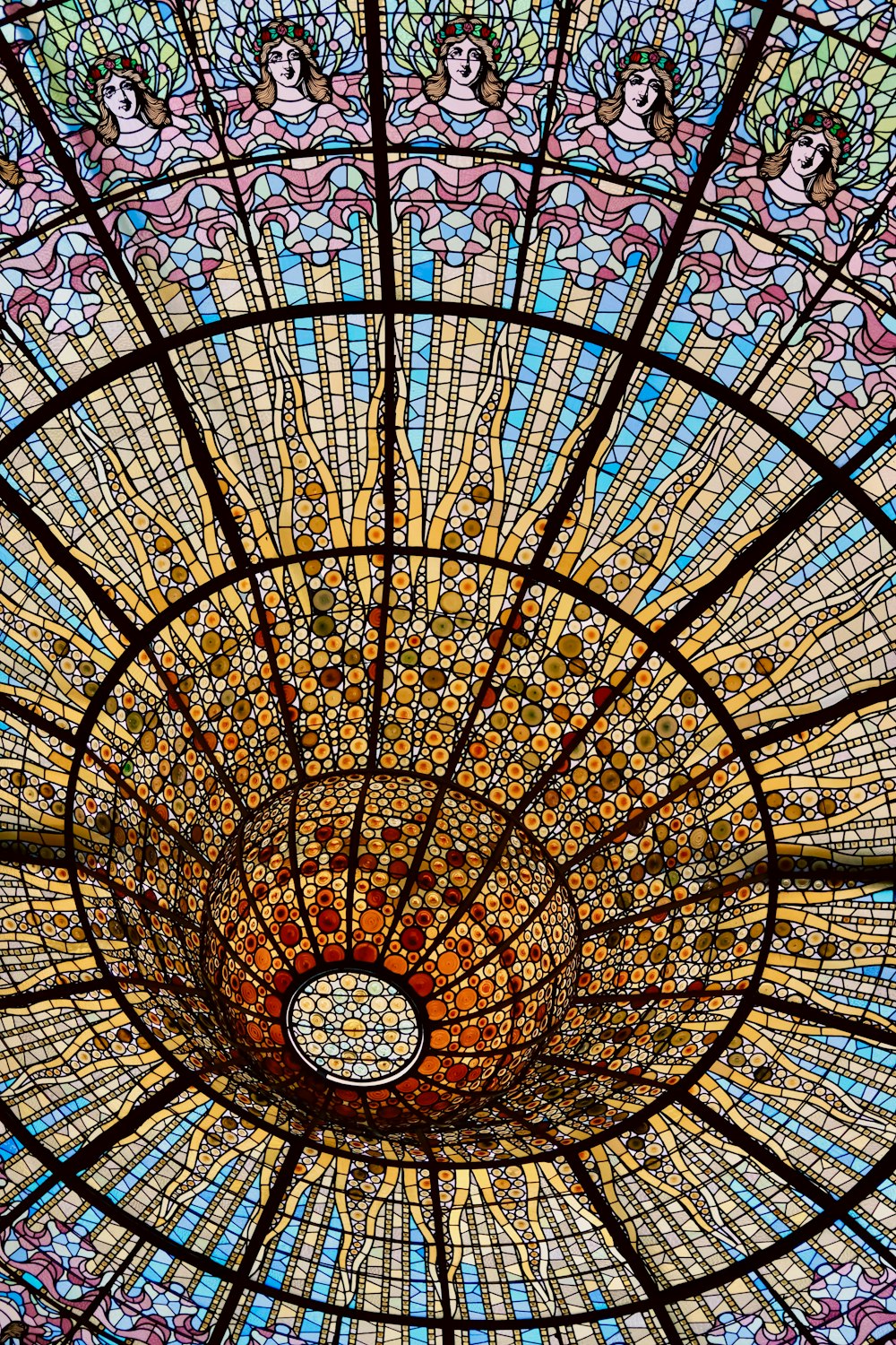 a glass ceiling with a circular design in the center