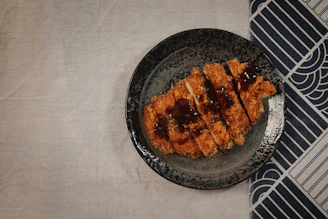 Spicy Nashville katsu bento plating with vibrant sauce and side dishes