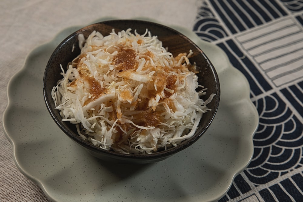 a bowl of food on a plate on a table