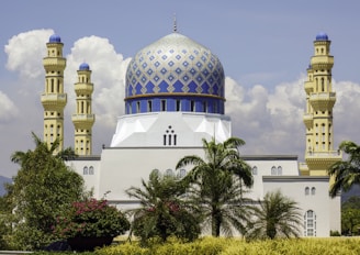 a large white building with a blue and gold dome