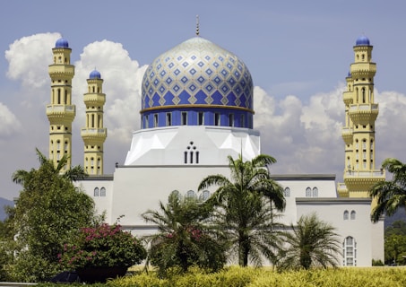 a large white building with a blue and gold dome