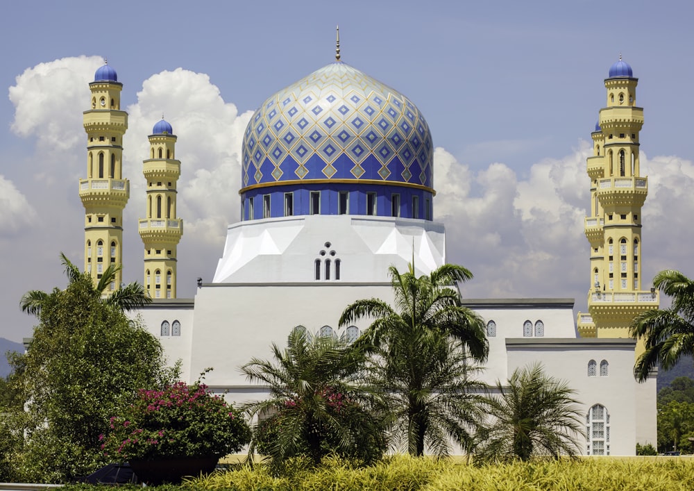 a large white building with a blue and gold dome
