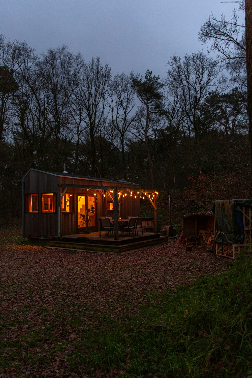 a small cabin in the woods at night