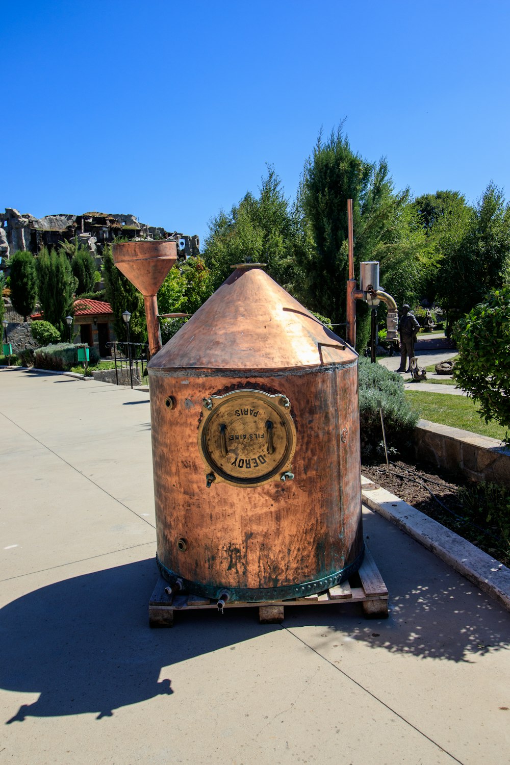 a large metal barrel sitting on top of a sidewalk