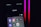 A smartphone screen displays a folder labeled 'Social,' containing icons for various social media apps, including Facebook, Instagram, Threads, X, LinkedIn, TikTok, and YouTube. The background is dark with pink and red neon lights.