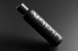 A sleek black matte packaging with subtle foil stamping highlighting the brand logo.