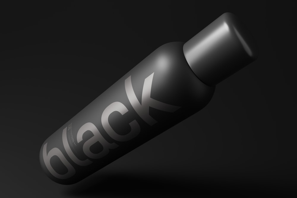 a close up of a black bottle on a black background