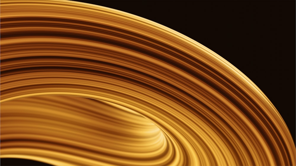 a close up of a yellow swirl on a black background