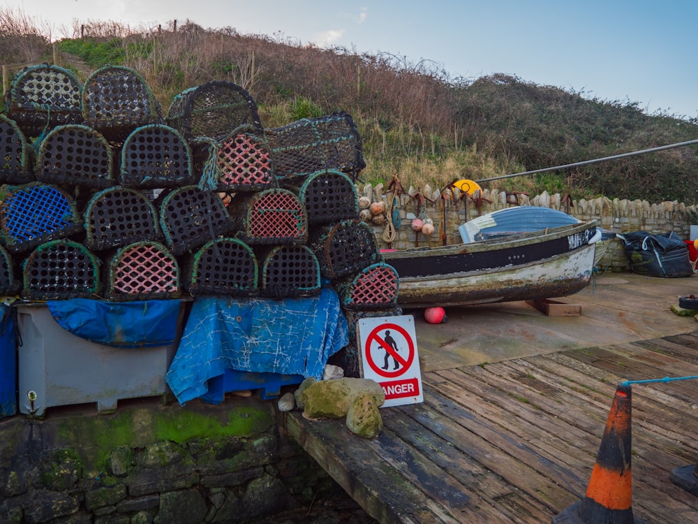 a pile of fishing nets sitting on top of a wooden dock