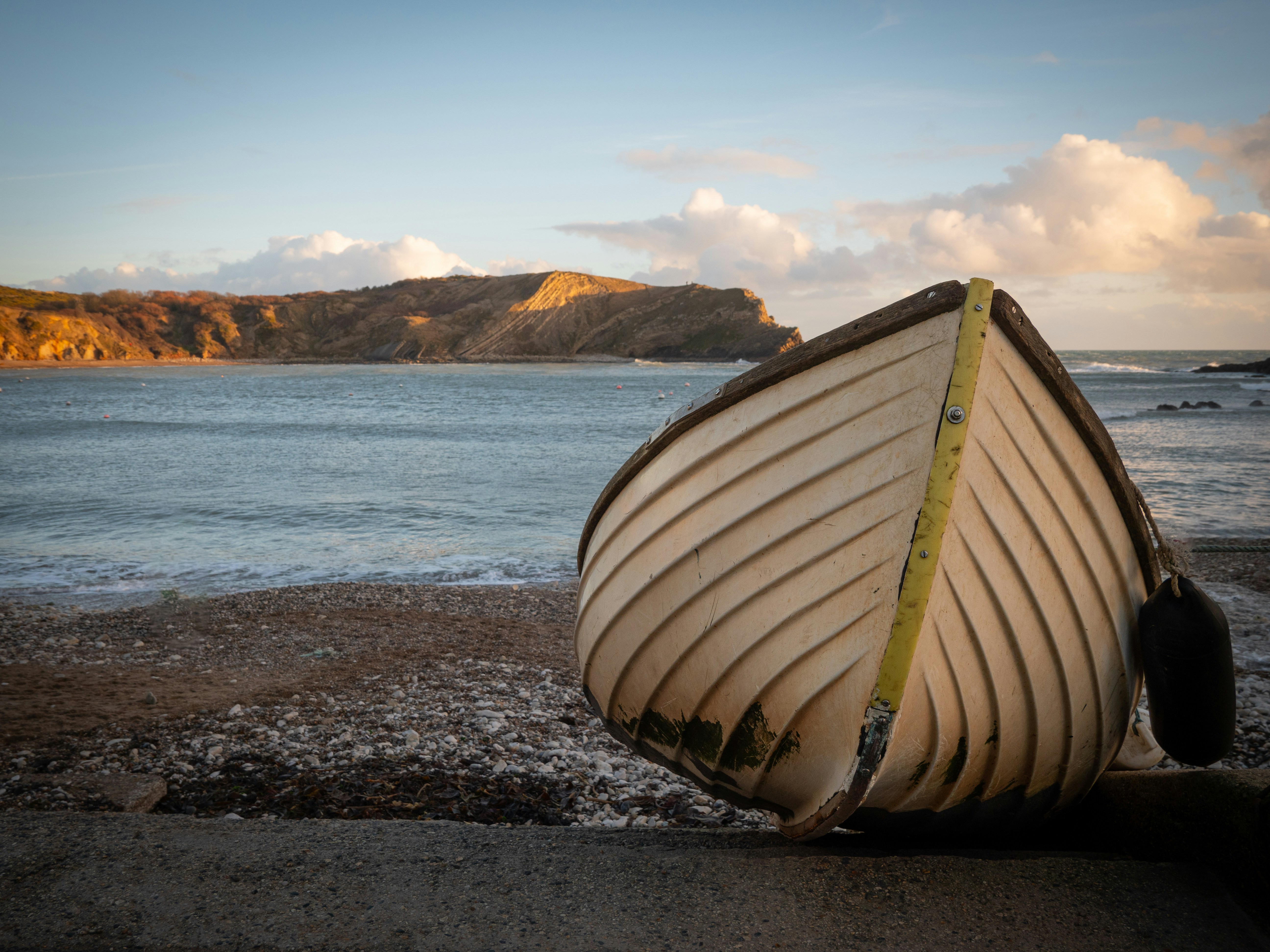 A boat sitting on top of a beach next to the ocean photo – Free Travel ...