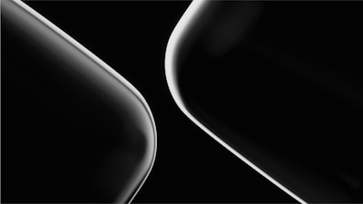 Two sleek, curved lines in a minimalist black and white composition, showcasing a modern and abstract design.