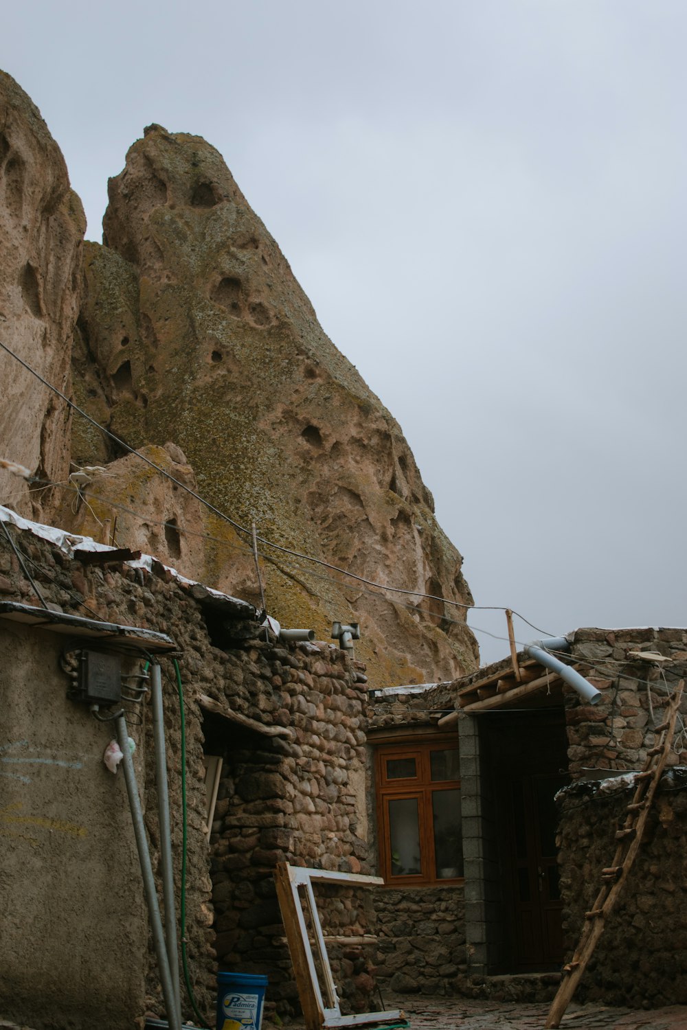 a stone building with a mountain in the background