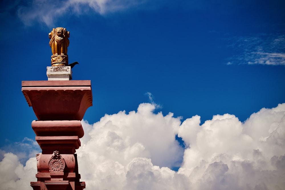 a statue of a lion on top of a pillar