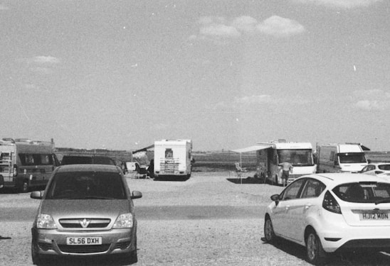 A professional team member reviewing fleet data on a tablet beside a row of parked RVs.