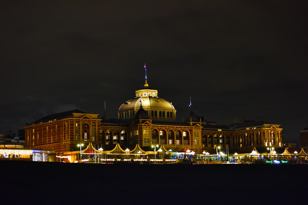 a large building lit up at night with lights