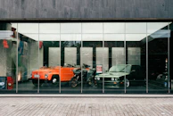 a reflection of a car and a motorcycle in a window