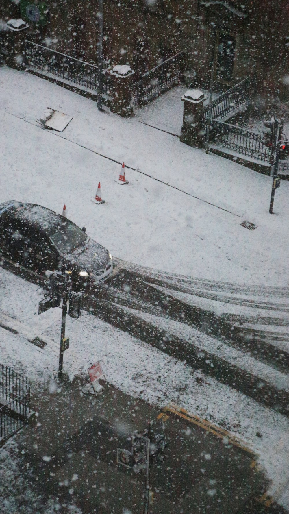 a car is parked on the side of the road in the snow