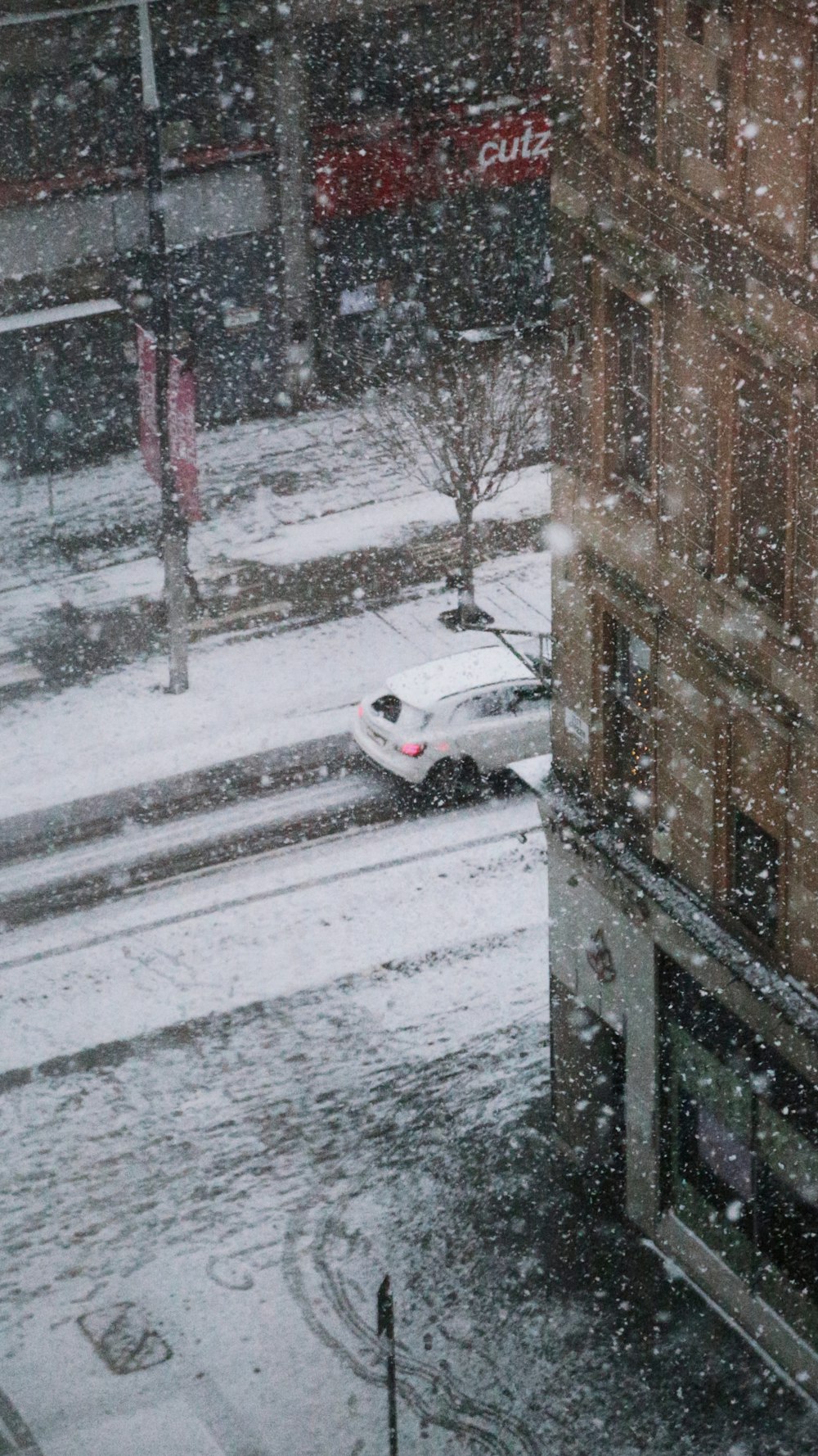 a car is parked on a snowy street