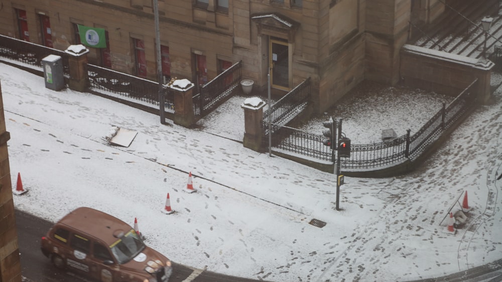 a city street covered in snow next to a tall building