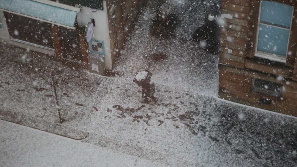 a person walking down a street in the snow