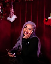 A friendly customer support agent with a headset in front of a purple-themed background.