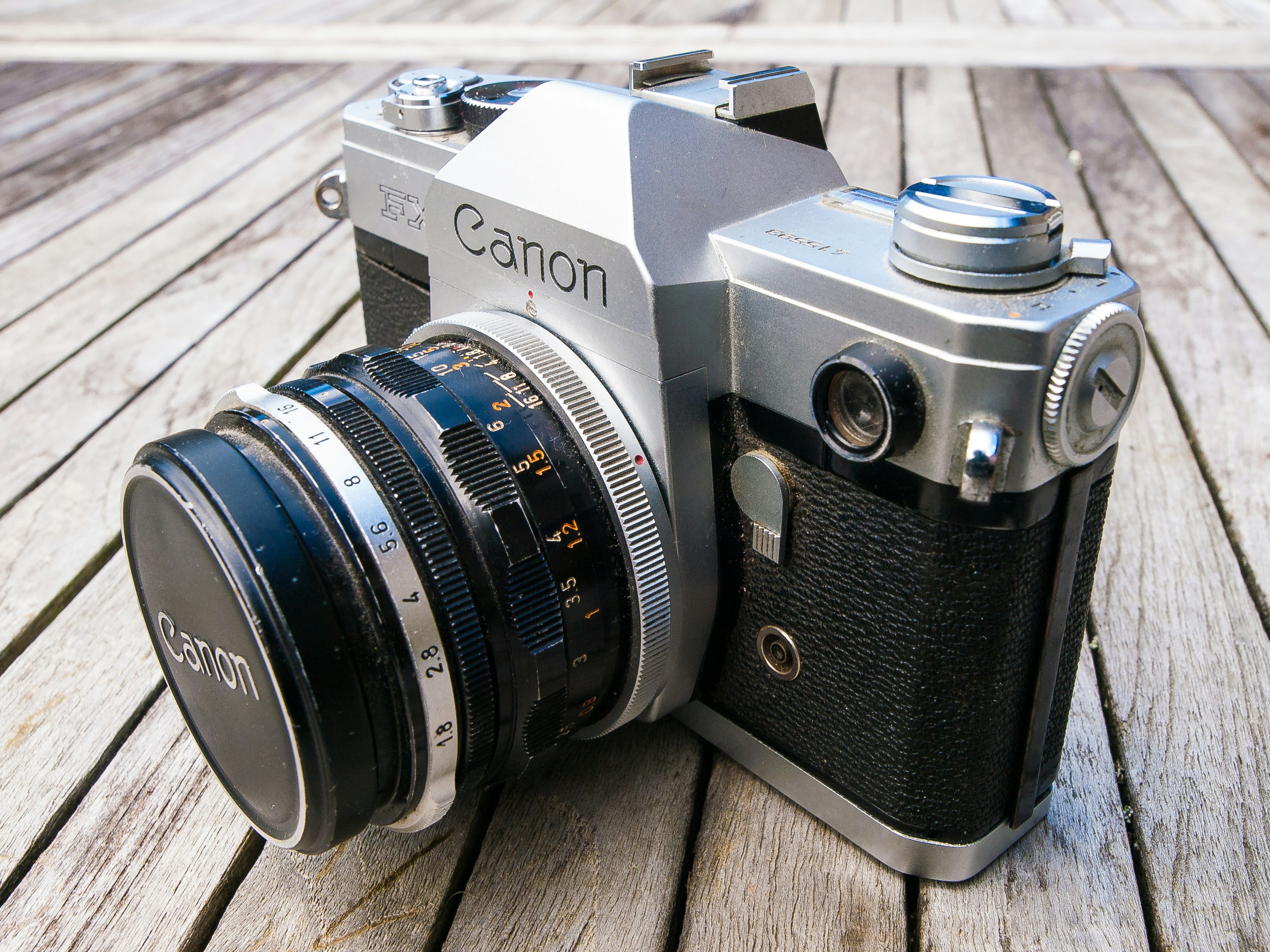 a close up of a camera on a wooden surface