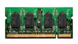 A compact green circuit board features multiple black rectangular chips surrounded by intricate gold pathways and connectors. The detailed design is typical of a RAM module used in computers.