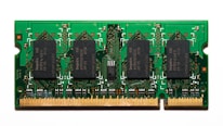A compact green circuit board features multiple black rectangular chips surrounded by intricate gold pathways and connectors. The detailed design is typical of a RAM module used in computers.