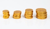 Stack of coins and financial graphs
