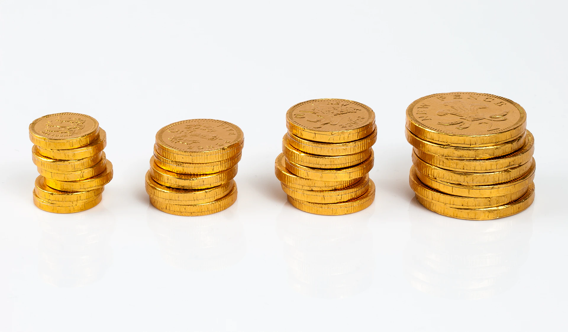 a stack of gold coins sitting next to each other