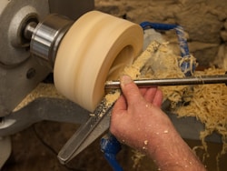 a man is working on a piece of wood