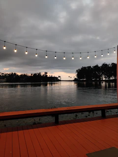 A cozy evening scene with twinkling fairy lights and reflections on the calm loch.