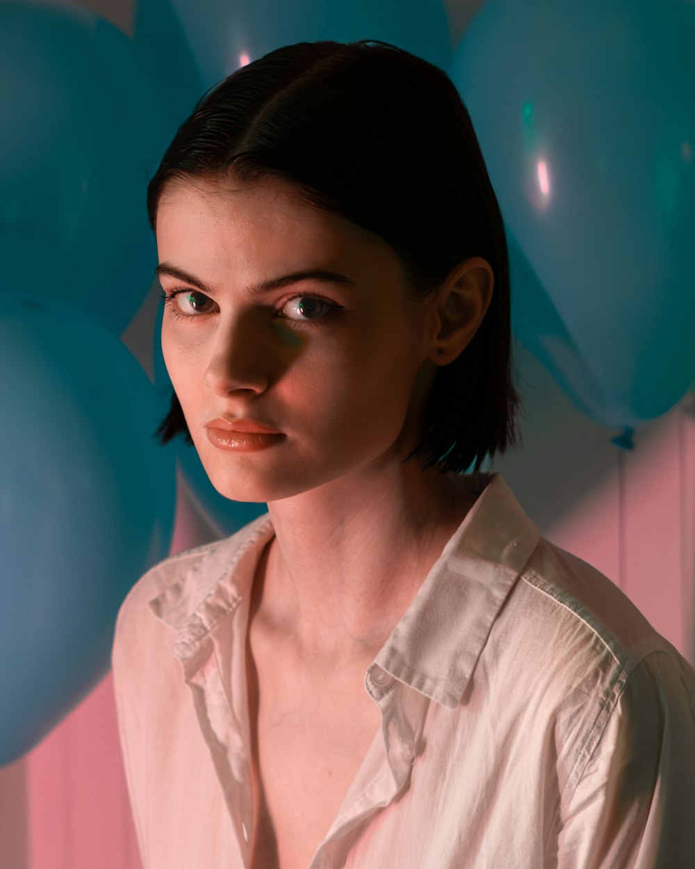 a woman standing in front of a bunch of balloons