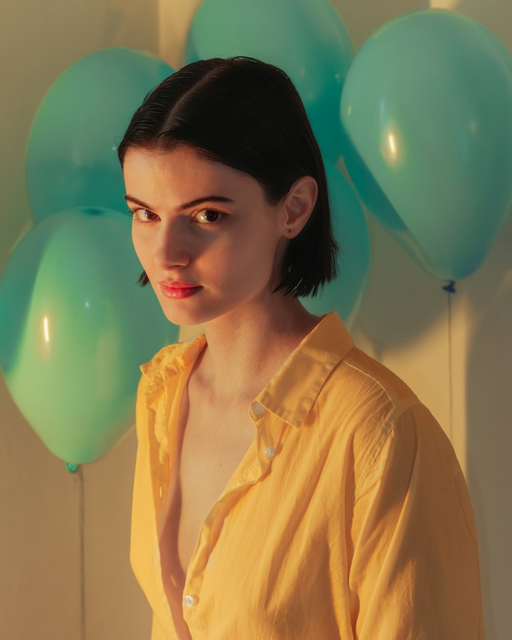 a woman standing in front of a bunch of balloons